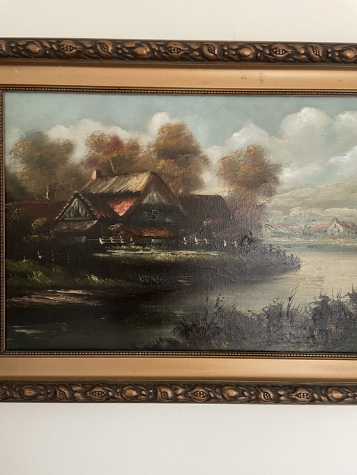 Peinture d'une ferme au bord de l'eau avec des couleurs chaudes et un beau cadre original