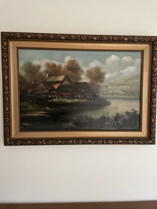 Peinture d'une ferme au bord de l'eau avec des couleurs chaudes et un beau cadre original