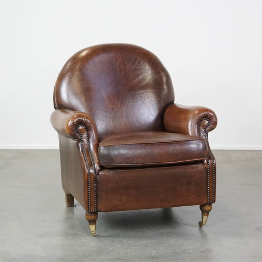 Fauteuil à roulettes en peau de mouton foncé