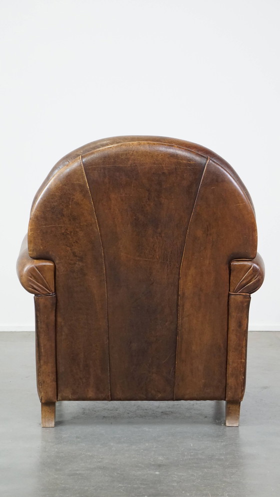 Image 1 of Fauteuil à roulettes en peau de mouton foncé