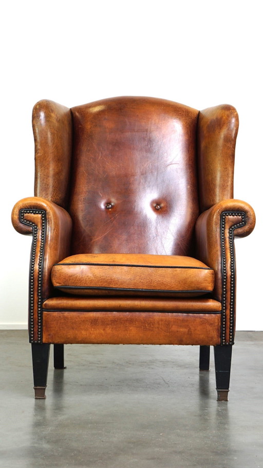 Grand fauteuil à oreilles en cuir de mouton