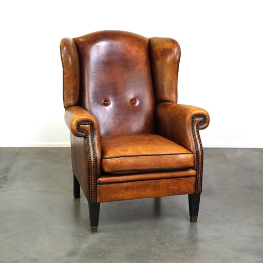 Grand fauteuil à oreilles en cuir de mouton