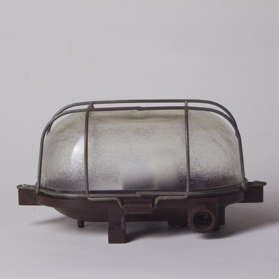 Image 1 of Industrielle Wandlampe aus Bakelit und Glas mit Metallkäfig, Tschechoslowakei 1960