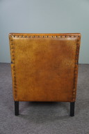 Art Deco Sessel mit schwarzen Paspeln und Ziernägeln