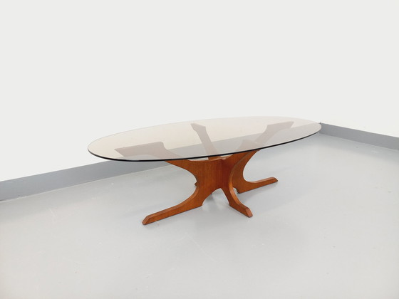 Image 1 of Vintage Hugues Poignant Ovaler Couchtisch aus Teakholz und Rauchglas aus den 1960er und 1970er Jahren
